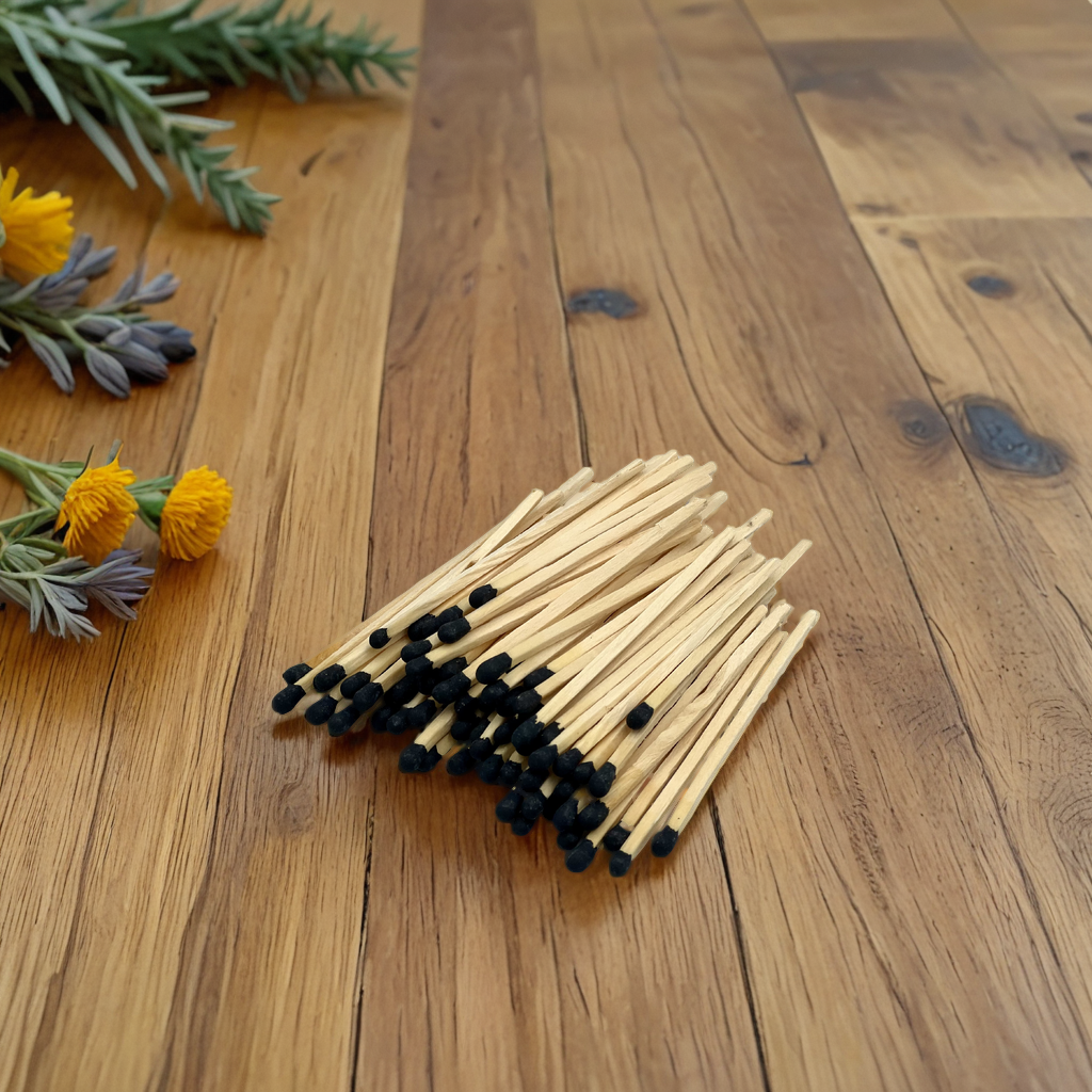 black tipped matches resting on wood countertop